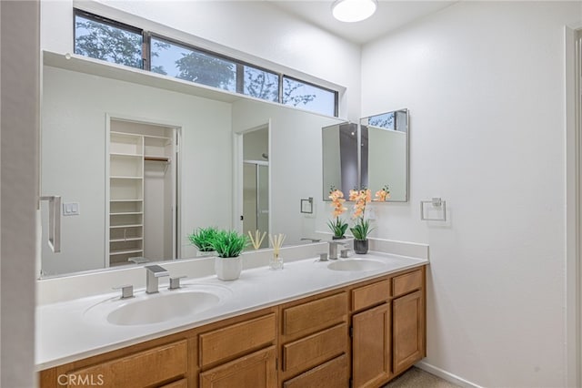 44118 Ruthron Ave, Lancaster, CA 93536 - full bath featuring double vanity, a walk in closet, and a shower with shower door