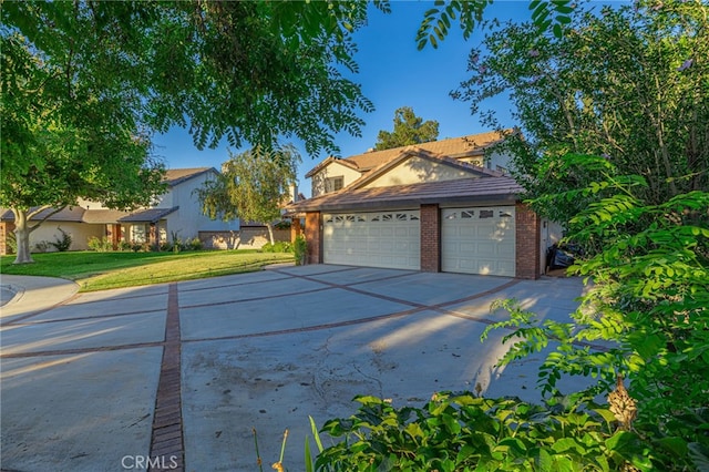 44118 Ruthron Ave, Lancaster, CA 93536 - view of front of home with a front yard, concrete driveway, brick siding, and an attached garage