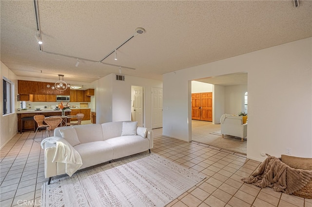 44118 Ruthron Ave, Lancaster, CA 93536 - living room featuring track lighting, light tile patterned floors, and a textured ceiling