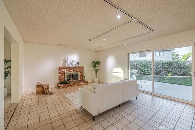44118 Ruthron Ave, Lancaster, CA 93536 - living area featuring track lighting, light tile patterned flooring, a brick fireplace, and a textured ceiling