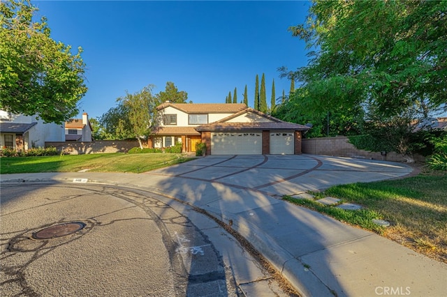 44118 Ruthron Ave, Lancaster, CA 93536 - traditional home with driveway, a front yard, and an attached garage