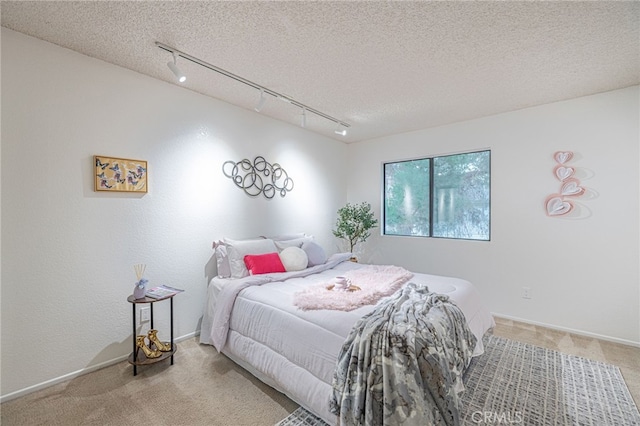 44118 Ruthron Ave, Lancaster, CA 93536 - bedroom with track lighting, light colored carpet, and a textured ceiling