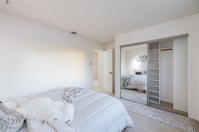 44118 Ruthron Ave, Lancaster, CA 93536 - bedroom with carpet flooring, a closet, and a textured ceiling