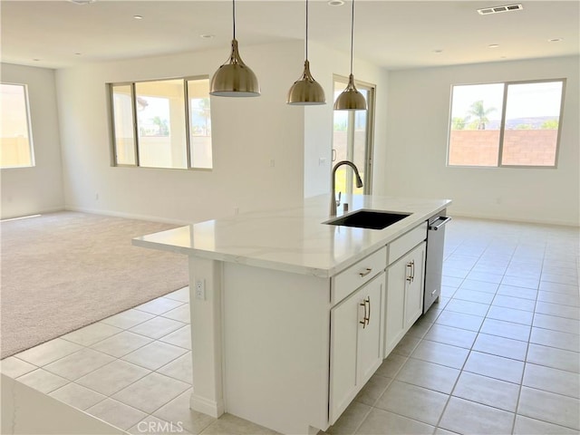 17727 Santa Lucia Ct, Riverside, CA 92503 - kitchen featuring light tile patterned floors, open floor plan, light colored carpet, a kitchen island with sink, and hanging light fixtures