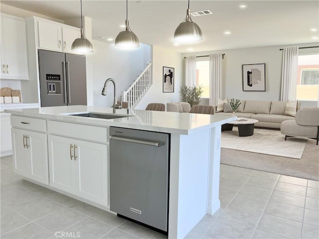 17727 Santa Lucia Ct, Riverside, CA 92503 - kitchen with stainless steel appliances, light countertops, light tile patterned floors, a center island with sink, and open floor plan