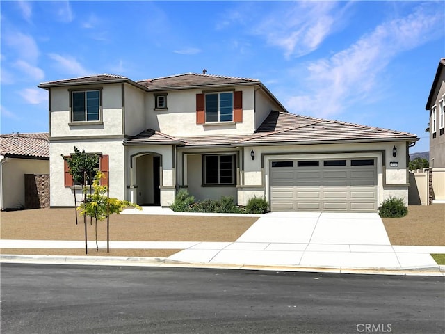 17727 Santa Lucia Ct, Riverside, CA 92503 - view of front facade with driveway, a tile roof, an attached garage, and stucco siding