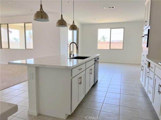 17727 Santa Lucia Ct, Riverside, CA 92503 - kitchen with light tile patterned floors, a kitchen island with sink, light stone countertops, white cabinetry, and pendant lighting