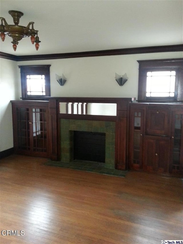 1165 N Lake Ave, Pasadena, CA 91104 - unfurnished living room with wood finished floors, a tile fireplace, crown molding, and healthy amount of natural light