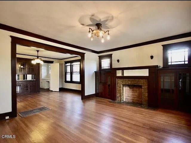 1165 N Lake Ave, Pasadena, CA 91104 - unfurnished living room with a chandelier, crown molding, wood finished floors, and a tile fireplace