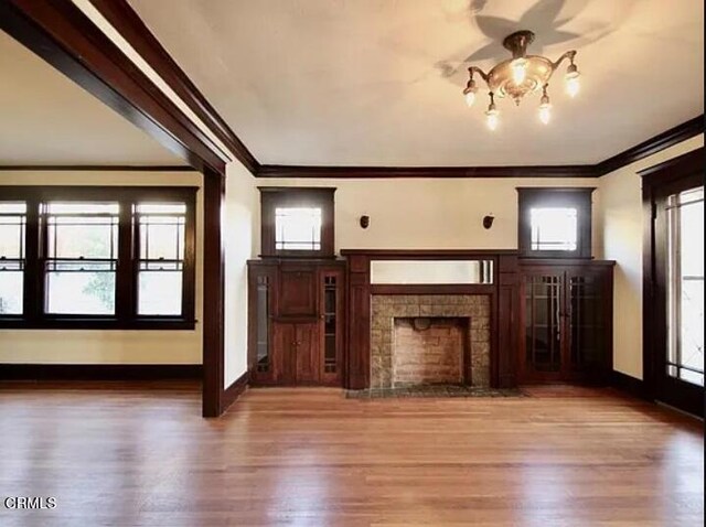1165 N Lake Ave, Pasadena, CA 91104 - unfurnished living room featuring ornamental molding, a tile fireplace, wood finished floors, and healthy amount of natural light