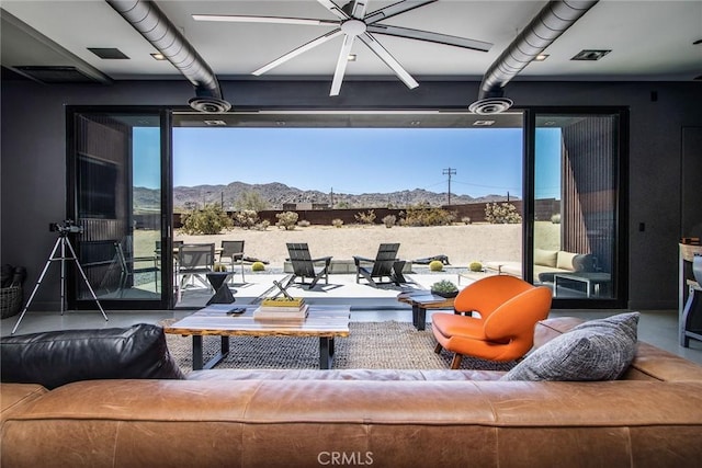 6640 Mount Shasta Ave, Joshua Tree, CA 92252 - living room with a mountain view, ceiling fan, and healthy amount of natural light