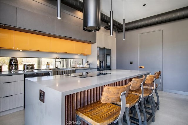 6640 Mount Shasta Ave, Joshua Tree, CA 92252 - kitchen featuring black appliances, a kitchen island, modern cabinets, a kitchen bar, and a high ceiling