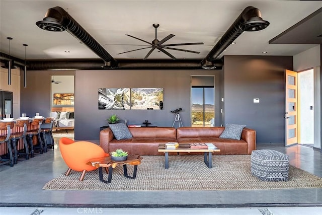 6640 Mount Shasta Ave, Joshua Tree, CA 92252 - living room featuring finished concrete floors and a ceiling fan
