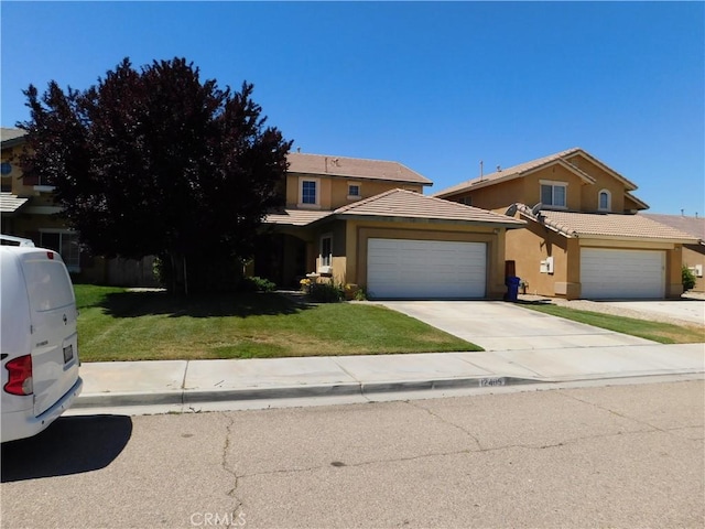 12405 Firefly Way, Victorville, CA 92392 - traditional home with stucco siding, a front lawn, an attached garage, concrete driveway, and a tiled roof