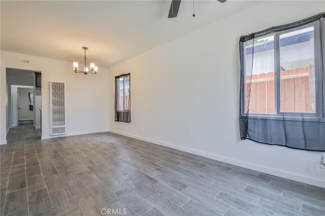 1964 E 114th St, Los Angeles, CA 90059 - spare room with a heating unit, a chandelier, wood finished floors, and a ceiling fan