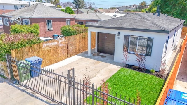 1964 E 114th St, Los Angeles, CA 90059 - view of front facade featuring stucco siding, concrete driveway, and roof with shingles