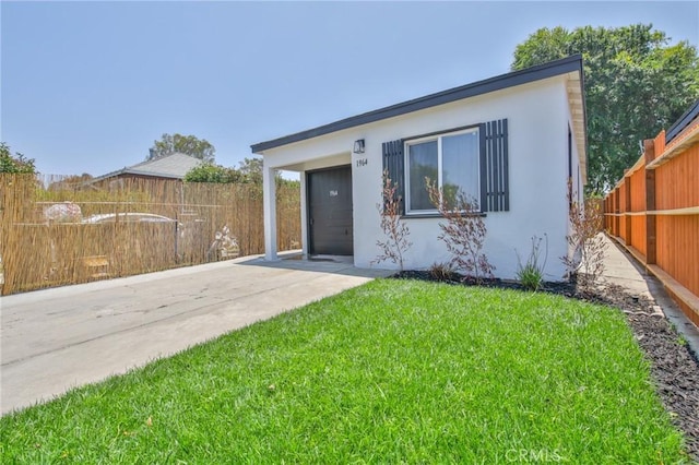 1964 E 114th St, Los Angeles, CA 90059 - view of front of property with stucco siding and concrete driveway