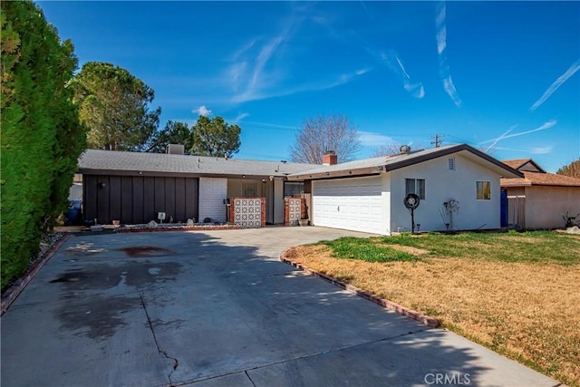 38847 2nd St E, Palmdale, CA 93550 - ranch-style house featuring a front yard, an attached garage, driveway, stucco siding, and a chimney
