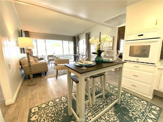 1441 Monterey Rd Unit M2-61J, Seal Beach, CA 90740 - kitchen featuring white oven, light wood finished floors, and lofted ceiling