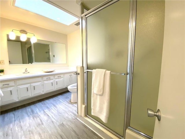 1441 Monterey Rd Unit M2-61J, Seal Beach, CA 90740 - bathroom featuring vanity, a shower with door, and wood finished floors