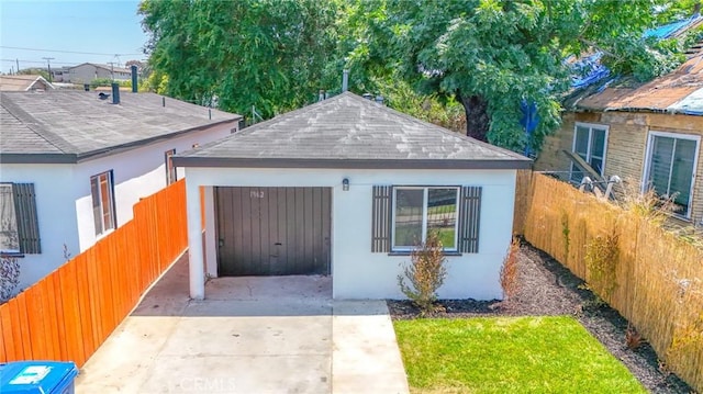 1962 E 114th St, Los Angeles, CA 90059 - view of front of home featuring concrete driveway, a shingled roof, stucco siding, and an outdoor structure