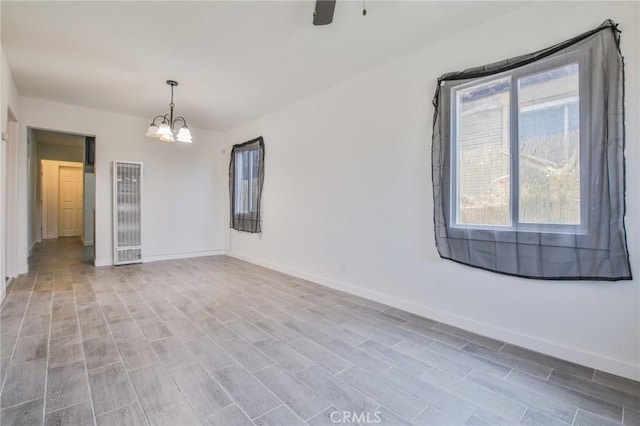 1962 E 114th St, Los Angeles, CA 90059 - spare room featuring a heating unit, a chandelier, and light wood-style flooring