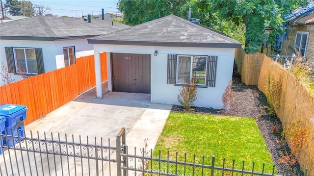 1962 E 114th St, Los Angeles, CA 90059 - bungalow featuring a shingled roof, concrete driveway, stucco siding, and a fenced front yard