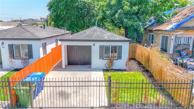 1962 E 114th St, Los Angeles, CA 90059 - view of front of property featuring a fenced front yard, stucco siding, roof with shingles, and an outdoor structure
