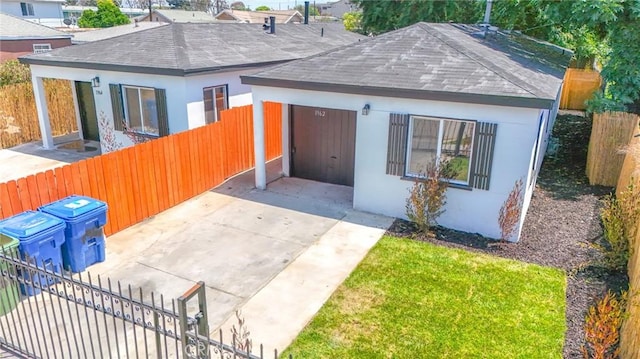 1962 E 114th St, Los Angeles, CA 90059 - view of front facade featuring a shingled roof, stucco siding, driveway, and a carport