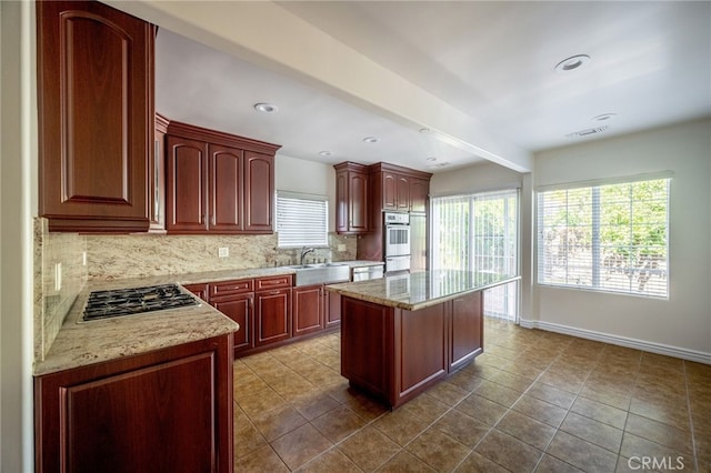 1038 N Columbus Ave, Glendale, CA 91202 - kitchen with backsplash, stainless steel appliances, plenty of natural light, a center island, and recessed lighting