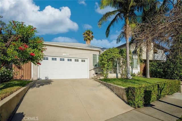 1038 N Columbus Ave, Glendale, CA 91202 - view of front of property with driveway, stucco siding, an attached garage, and a front yard