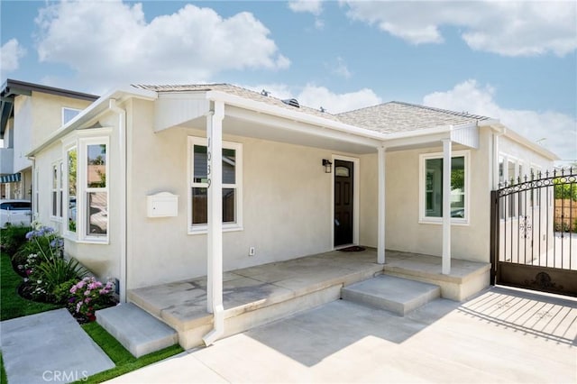 1038 N Columbus Ave, Glendale, CA 91202 - rear view of property featuring stucco siding and a gate