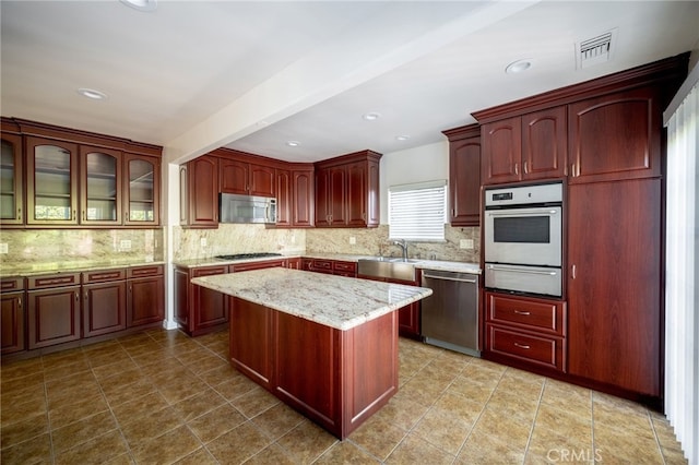 1038 N Columbus Ave, Glendale, CA 91202 - kitchen with stainless steel appliances, a warming drawer, dark brown cabinets, decorative backsplash, and recessed lighting