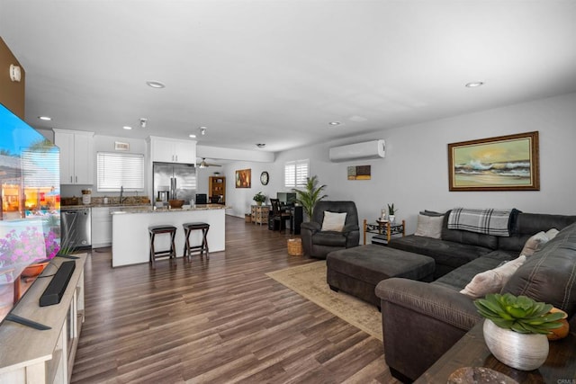 9181 Bloomdale St, Santee, CA 92071 - living room with an AC wall unit, dark wood-style flooring, ceiling fan, and recessed lighting