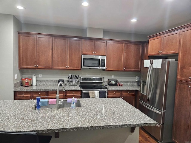 7508 Eagle Dr, Santee, CA 92071 - kitchen featuring appliances with stainless steel finishes, recessed lighting, light stone countertops, a kitchen breakfast bar, and dark wood-style floors