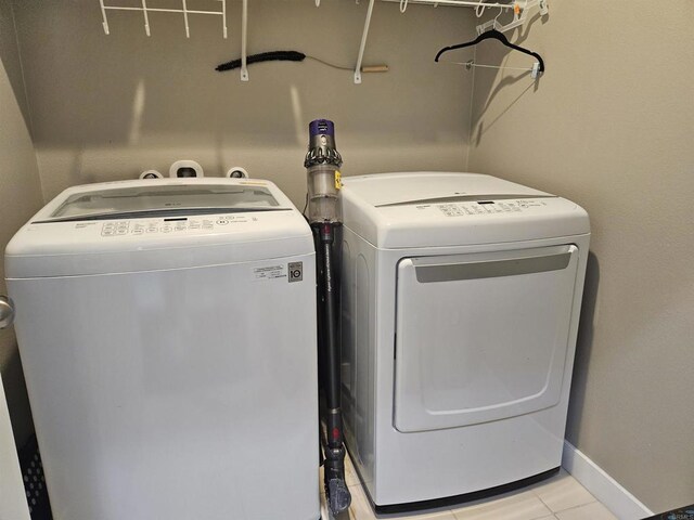 7508 Eagle Dr, Santee, CA 92071 - washroom with washing machine and clothes dryer and light tile patterned floors