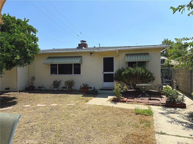 7135 Sultana Ave, San Gabriel, CA 91775 - view of front of property with stucco siding, a chimney, and a patio area