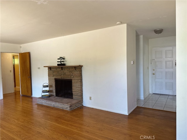 7135 Sultana Ave, San Gabriel, CA 91775 - unfurnished living room with wood finished floors and a stone fireplace