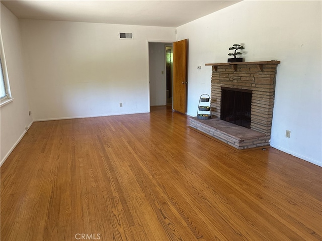 7135 Sultana Ave, San Gabriel, CA 91775 - unfurnished living room featuring a stone fireplace and wood finished floors