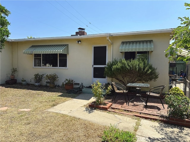 7135 Sultana Ave, San Gabriel, CA 91775 - view of front facade featuring stucco siding, a patio, and a chimney