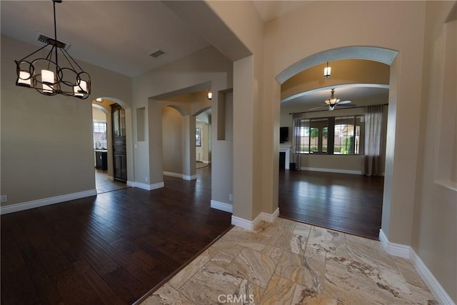 125 W Franklin Ave, Ridgecrest, CA 93555 - foyer with arched walkways, hardwood / wood-style flooring, and a chandelier