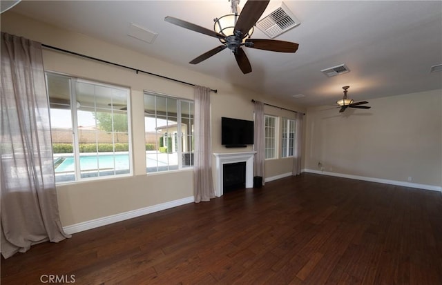 125 W Franklin Ave, Ridgecrest, CA 93555 - unfurnished living room with dark wood finished floors, ceiling fan, and a fireplace