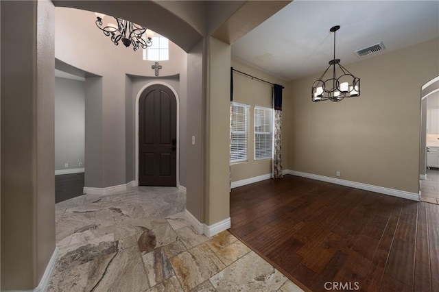 125 W Franklin Ave, Ridgecrest, CA 93555 - entryway with arched walkways, a chandelier, and wood finished floors