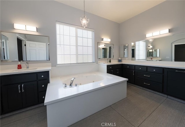 125 W Franklin Ave, Ridgecrest, CA 93555 - full bath featuring two vanities, a whirlpool tub, and a chandelier