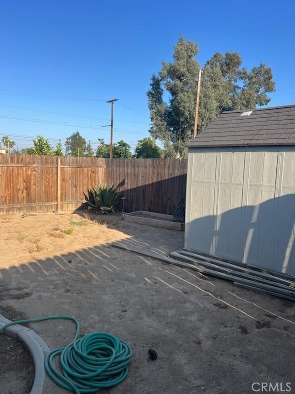 942 Front St, Perris, CA 92570 - view of parking / parking lot with a storage shed