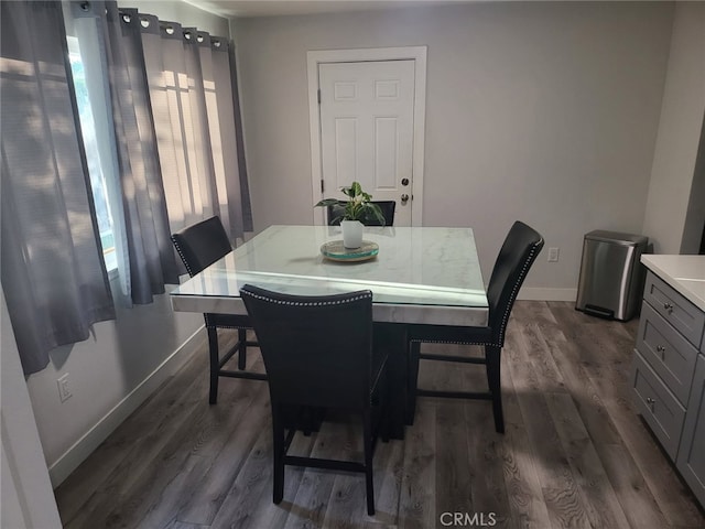 942 Front St, Perris, CA 92570 - dining room featuring baseboards and dark wood-style flooring