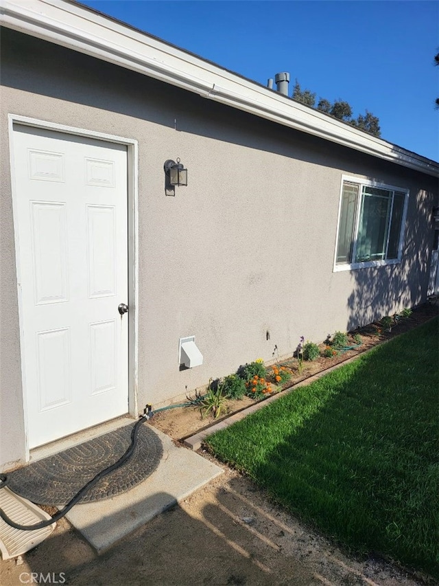 942 Front St, Perris, CA 92570 - entrance to property with stucco siding and a yard