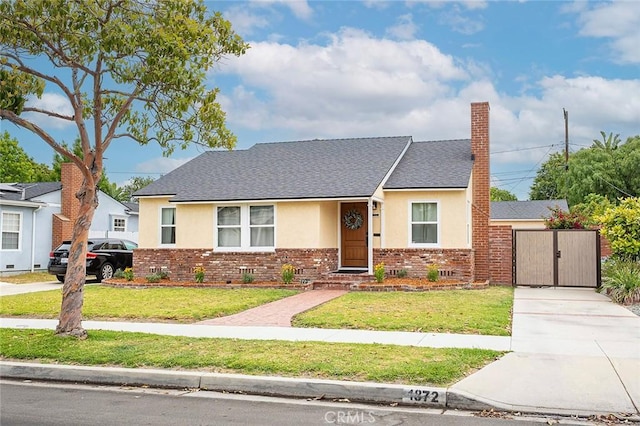 1872 Tulane Ave, Long Beach, CA 90815 - view of front of house featuring stucco siding, concrete driveway, brick siding, and a front yard
