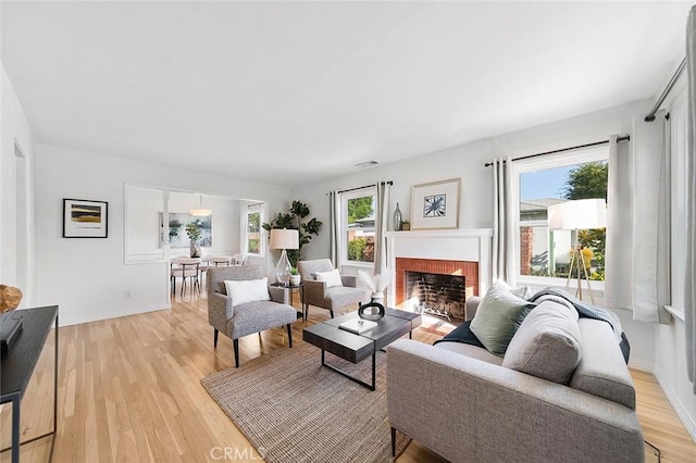 1872 Tulane Ave, Long Beach, CA 90815 - living area with light wood-style floors and a brick fireplace