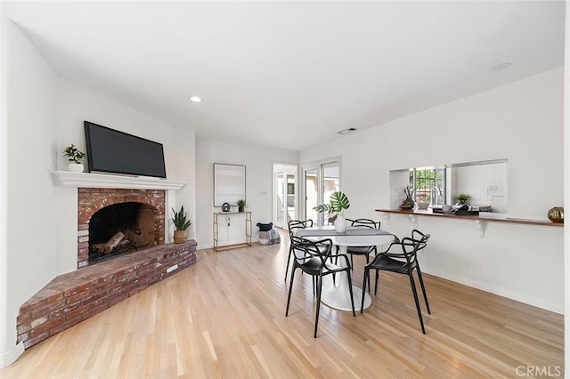 1872 Tulane Ave, Long Beach, CA 90815 - dining area with wood finished floors, a fireplace, and recessed lighting